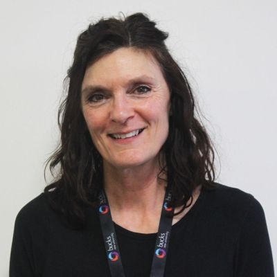 A head and shoulders shot of a smiling Susan Perryman wearing a land yard with a black jumper