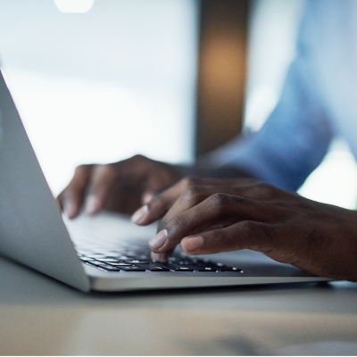 Male hands typing on laptop