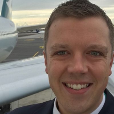 Darren Palmer stood in front of an airplane wing