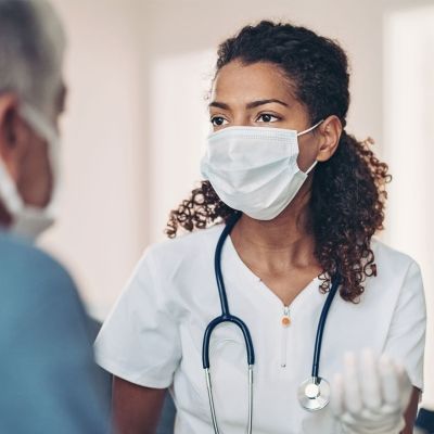Female nurse consulting elderly patient