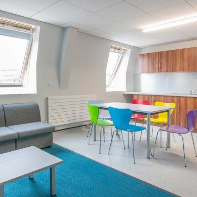 a sofa, table and chairs and kitchen fittings and equipment inside Windsor House accommodation