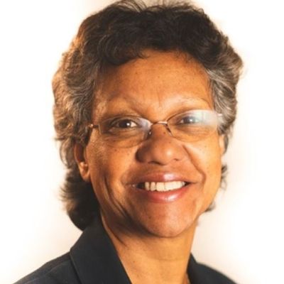 Head shot of a smiling Annet Gamell wearing glasses and stood facing the camera