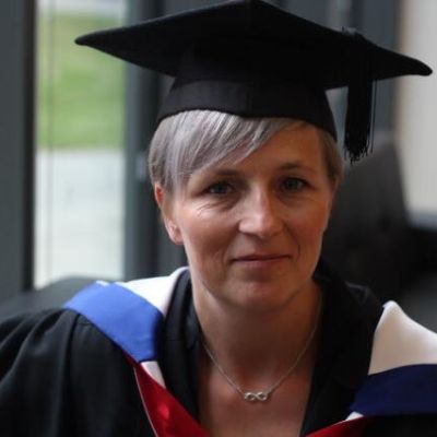 Head and shoulders shot of Carla Avery on her graduation day wearing her gown and hat