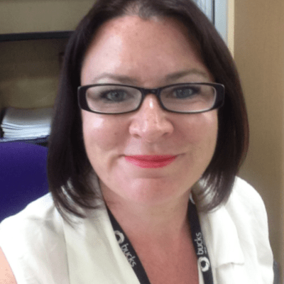 A head and shoulders shot of a smiling Ruth Trout wearing glasses, a land yard and a white top looking directly into the camera