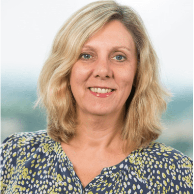 A head and shoulders shot of a smiling Jackie Westaway standing face on and looking directly into the camera