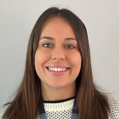 Headshot of a smiling Samantha Bautista wearing a BNU land yard and looking directly into the camera