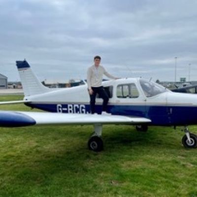 Ed Booth student stood on a plane at airpark