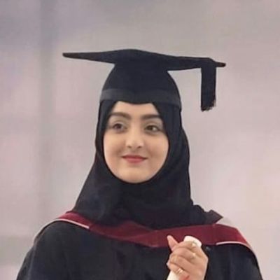 Headshot of a smiling graduate in their graduation gown and hat