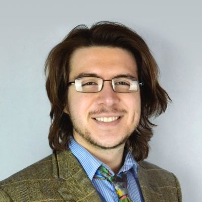 A headshot of Martin Matus Davis, a lecturer at BNU, wearing glasses.