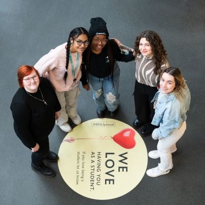 Group of BNU students in gateway by love sign