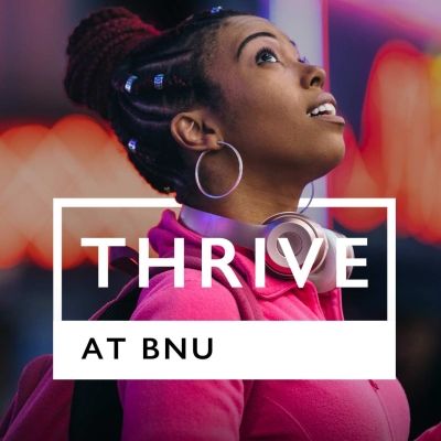 Thrive at BNU text on top of a girl looking up to the sky.