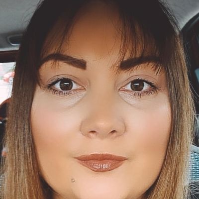 Children's Nurse Megan White stood in her graduation robe smiling.