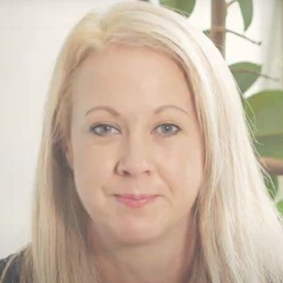 A head and shoulders shot of a smiling Suzanne Doria wearing a green shirt looking directly into the camera