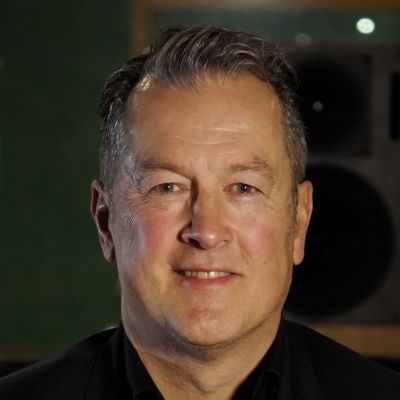 A headshot of Russel Stone, smiling towards the camera.