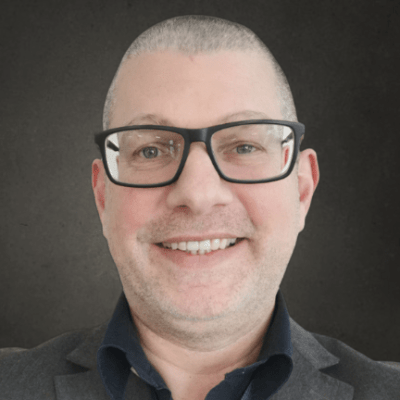 Headshot of Senior Lecturer Elliot Rose smiling to the camera.