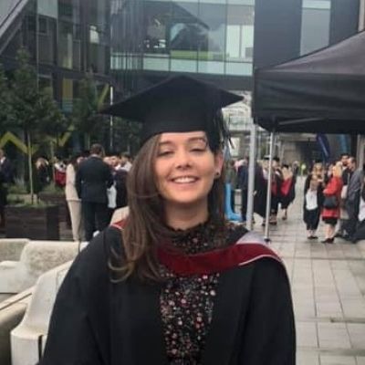 katie Pusey, Sports Therapy graduate in graduation gown and hat.