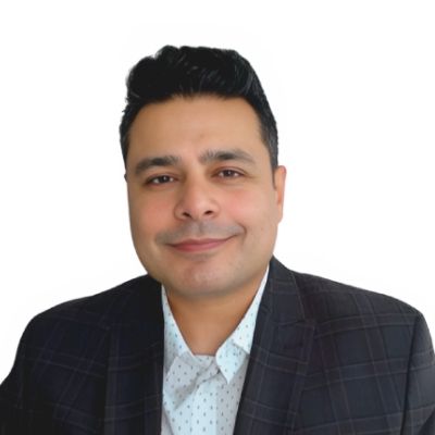 Photo of Adnan, who has light brown skin and dark hair, and is wearing a suit jacket