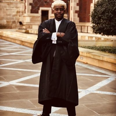 Photo of Theo, a black man wearing a Barrister's wig and robes