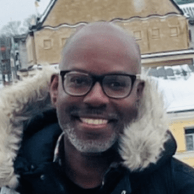 Headshot of Nickey Hardy, a Senior Lecturer at BNU wearing a coat and glasses.