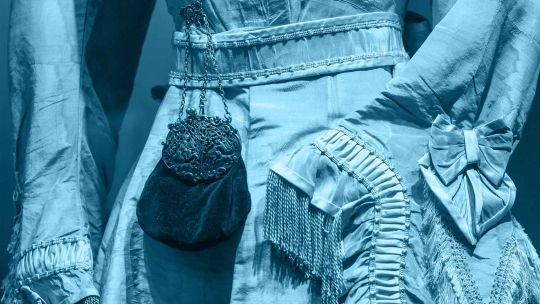 A close up of the midline of a blue victorian style dress 