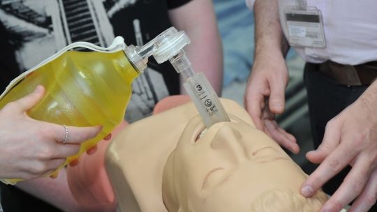 Bucks lecturer demonstrating use of a breathing aid device on a mannequin