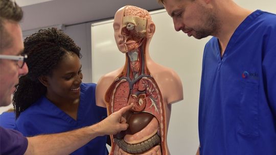 Bucks lecturer showing students an inside section of a mannequin