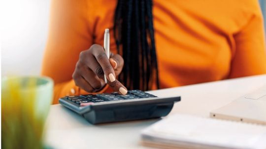 A close up of a calculator on a table student typing office