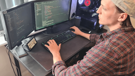 Justin looking at two computer screens