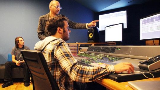 two men looking at the controls 