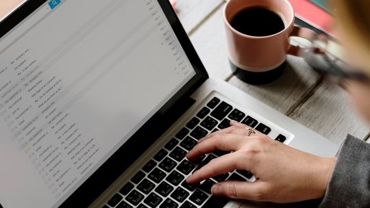 Hand typing in laptop