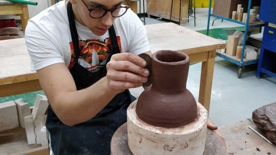 Student working in ceramics workshop 