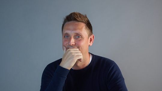 Simon Llyod head and shoulders picture with his right hand over his mouth