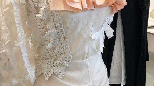 Close up of costume design white dress with ruffles 