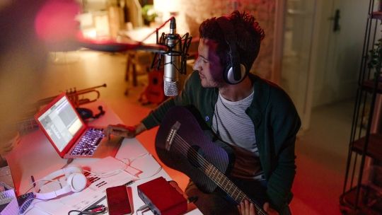 Source Young musician making music in home music studio