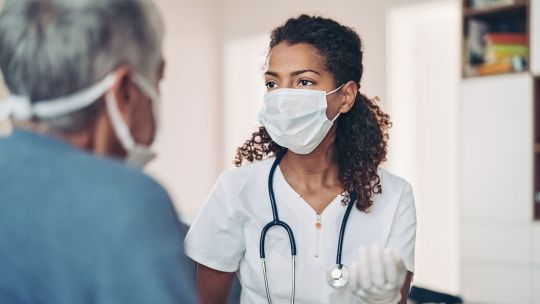 Female nurse consulting elderly patient