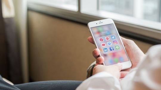 Person on Iphone with social media page open