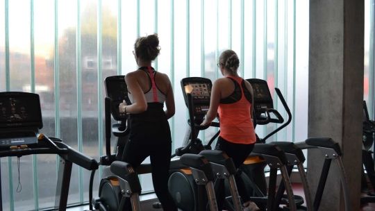 Two ladies on running machines
