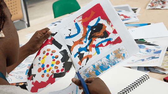 A female student cutting through paper