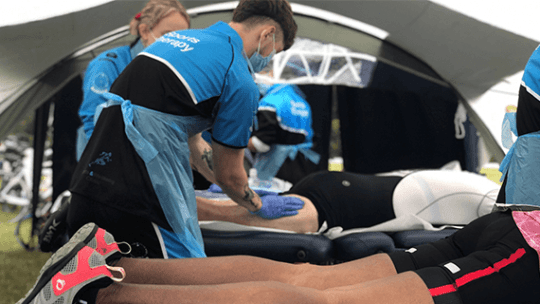 Student in BNU uniform carrying out therapy on runner