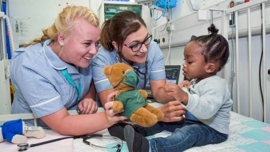 Children nurses with baby