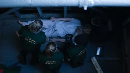 A team of students treat an elderly female (realistic manikin) following a fall