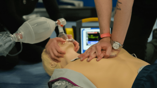 Students demonstrating essential life support and CPR on a patient simulator