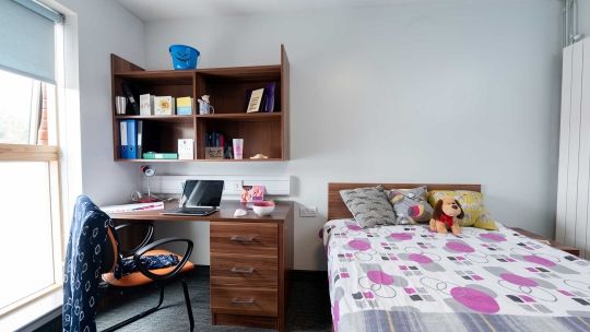 Windsor House bedroom including bed, desk, shelves