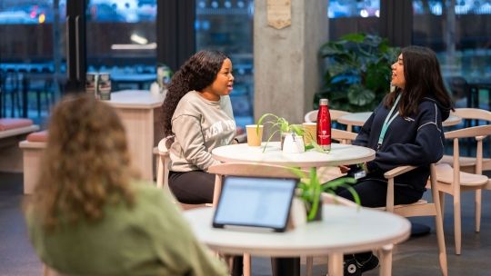 Two students sat together in the Garden Cafe