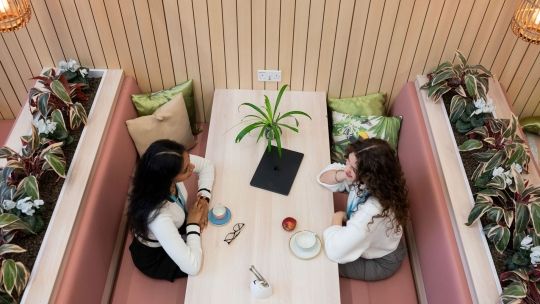 Two students sat together in the Garden Cafe