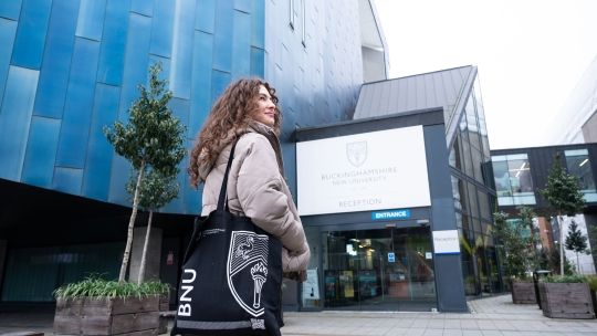 Female student outside gateway building on High Wycombe campus