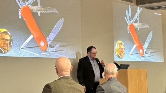 Professor Will Broughton stands at lectern