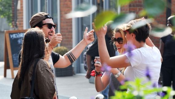 four students celebrating outside a restaurant