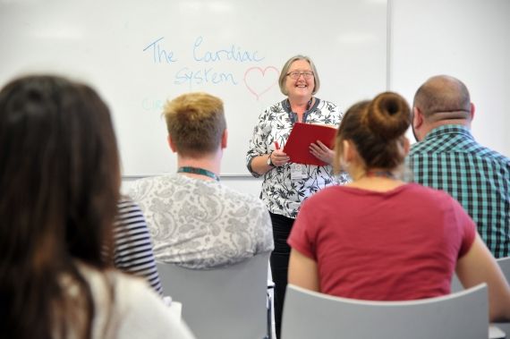 Nursing lecturer teaching a group of students
