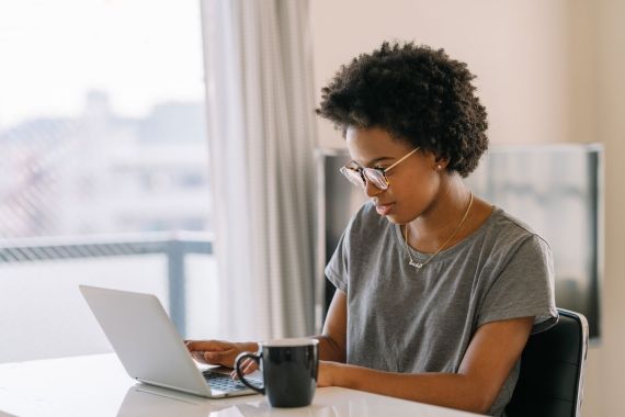 Young female student on a laptop at desk